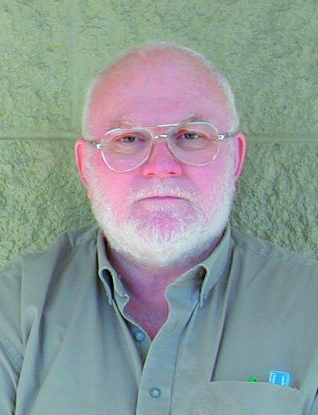 Archival photograph of James Summerton standing against a pale masonry wall