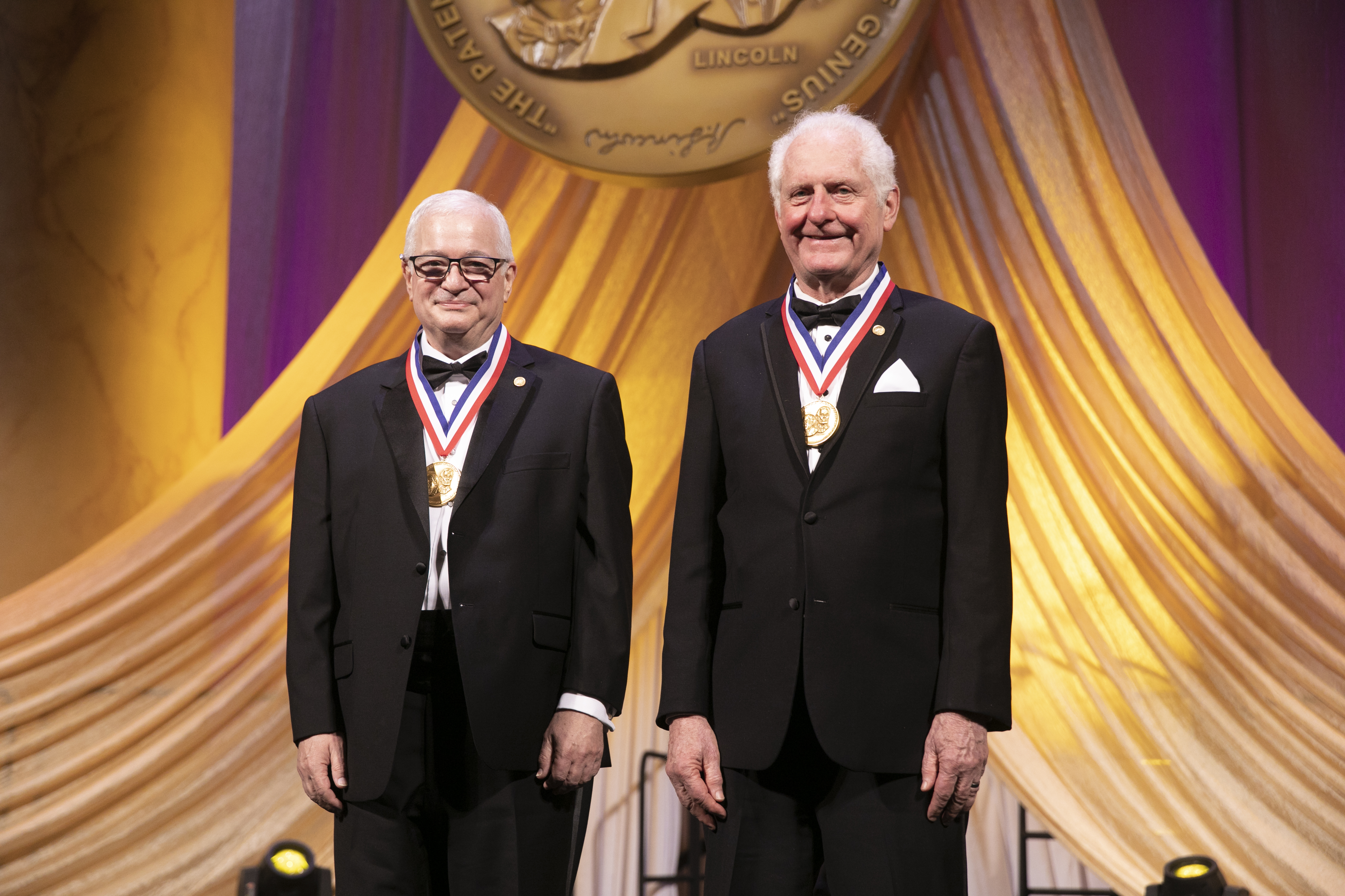 Jeff Kodosky, left, and James Truchard, right, wearing medals at their National Inventors Hall of Fame induction ceremony.