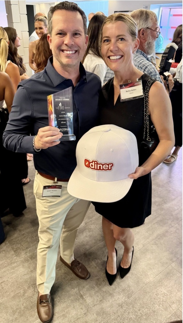 Jamie Baxter and Retta Kekic at the 2026 AZ Inno Fire Awards, holding an award and an oversized diner cap