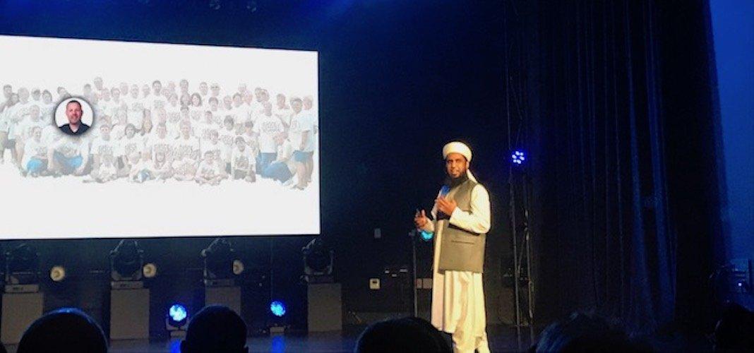 Jamil Ahmed Sukhera presenting on stage beside a projected slide at an OCEAN startup event