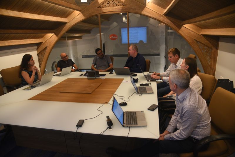 Xpedeon and JN Bentley colleagues discussing work around a conference table in Mumbai