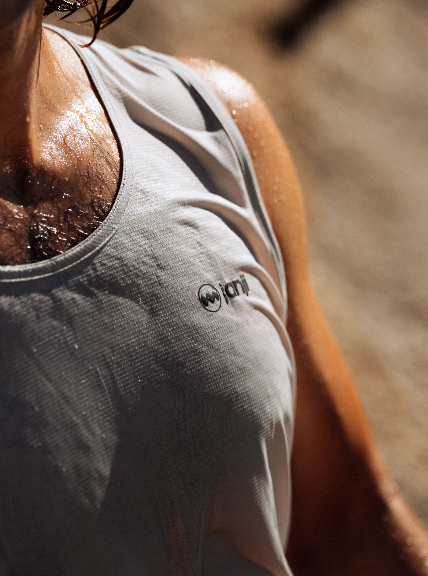 Close-up of a runner wearing a Janji singlet outdoors