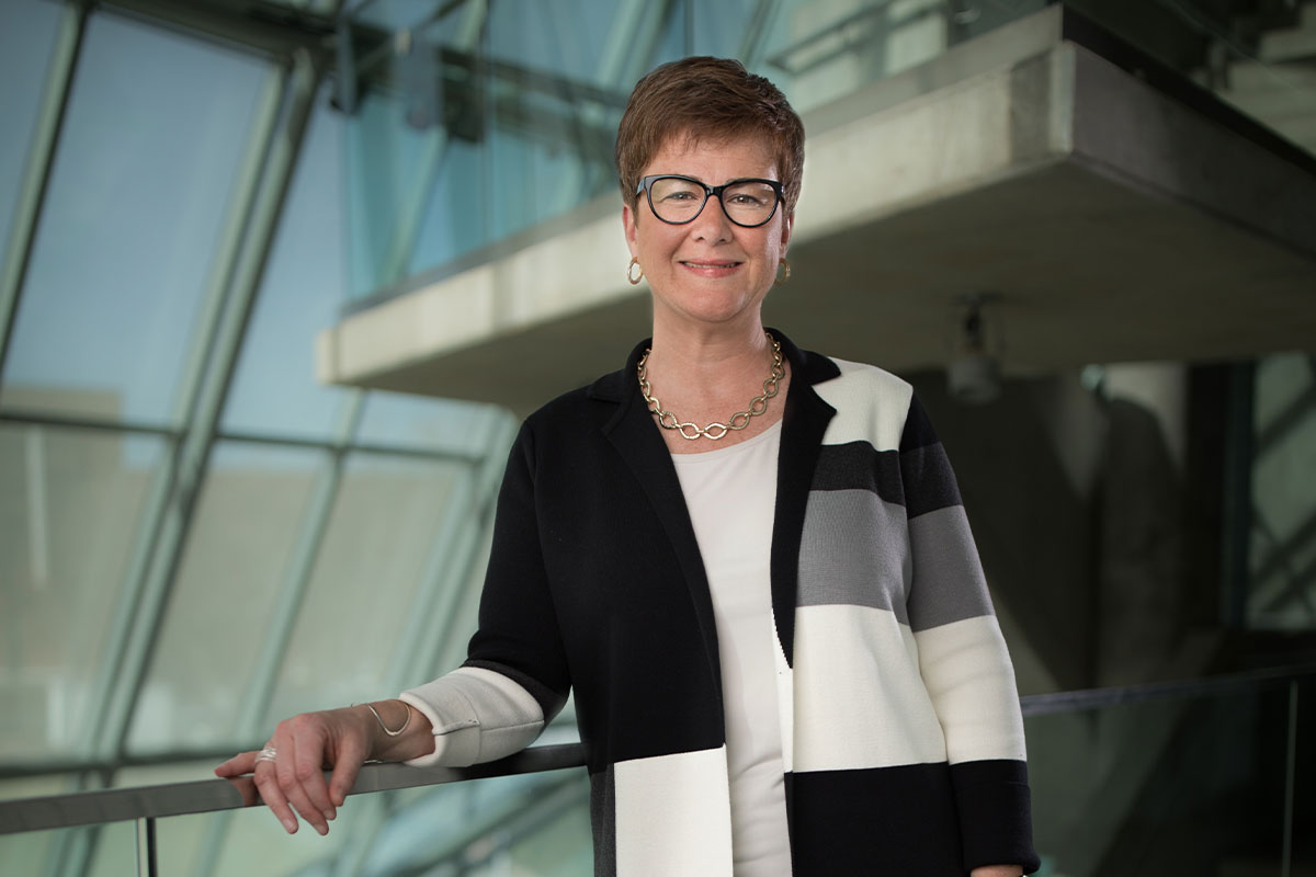 JANSON founder Janet Chihocky standing in a glass-lined atrium