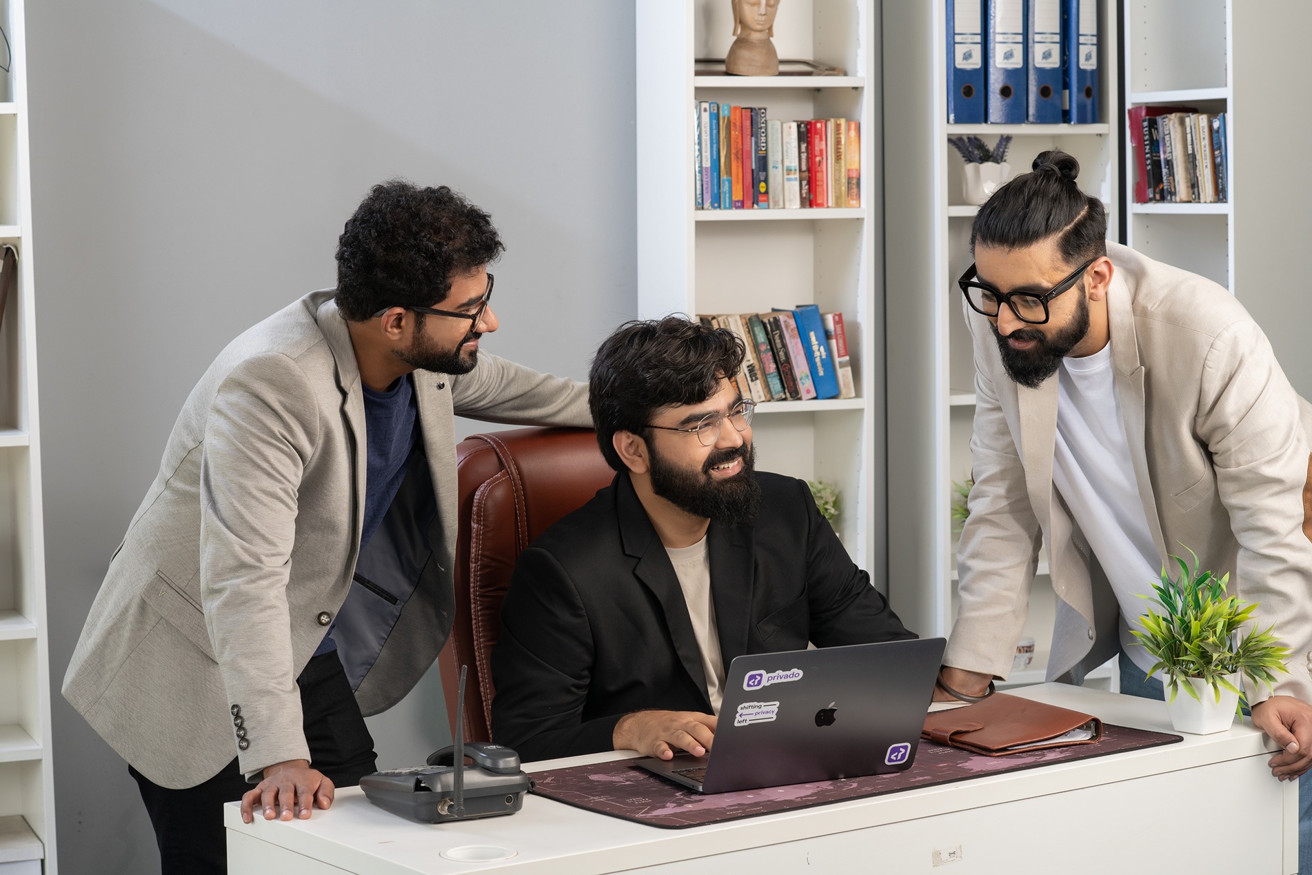 Privado AI co-founders Prashant Mahajan, Vaibhav Antil and Jasdeep Cheema gathered around a laptop