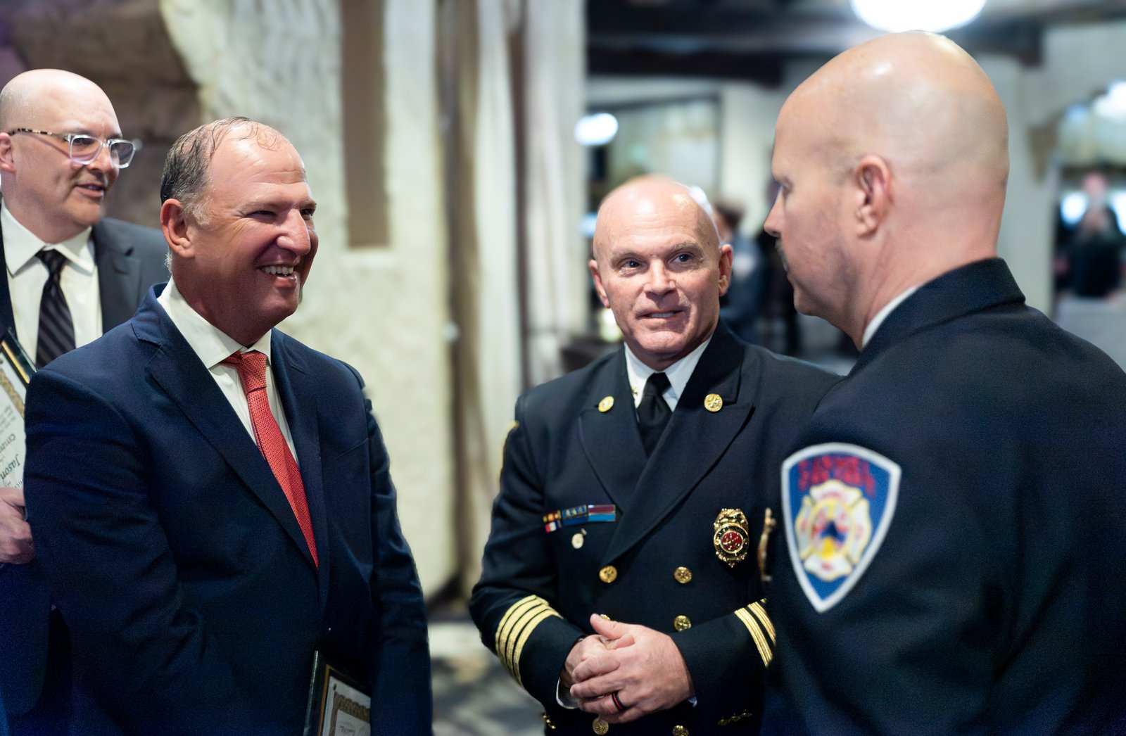 Jason Archer and Baker Hill colleagues speaking with Indianapolis fire officials at a recognition ceremony