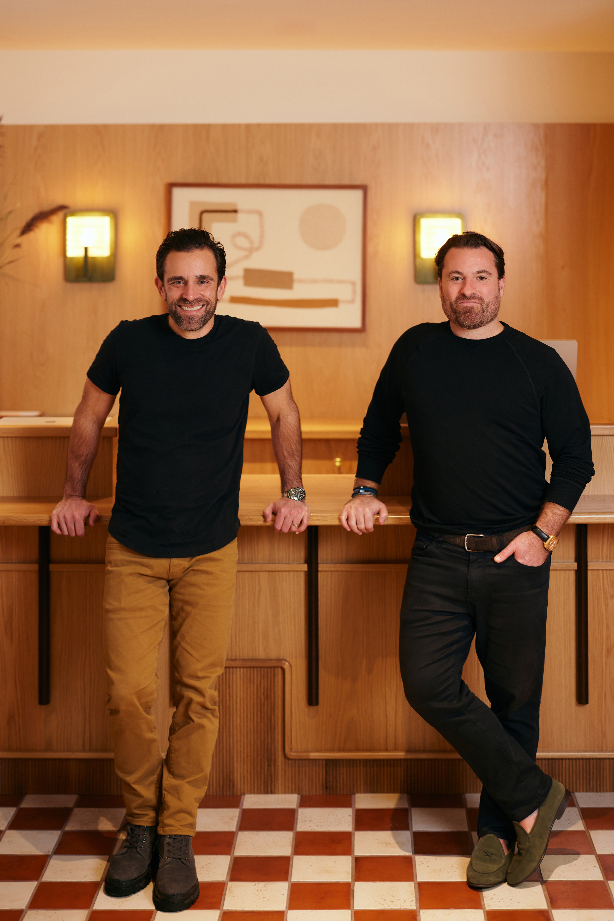 Blue Flag Capital co-founders Brad Guidi and Jason Brown together in a wood-paneled interior