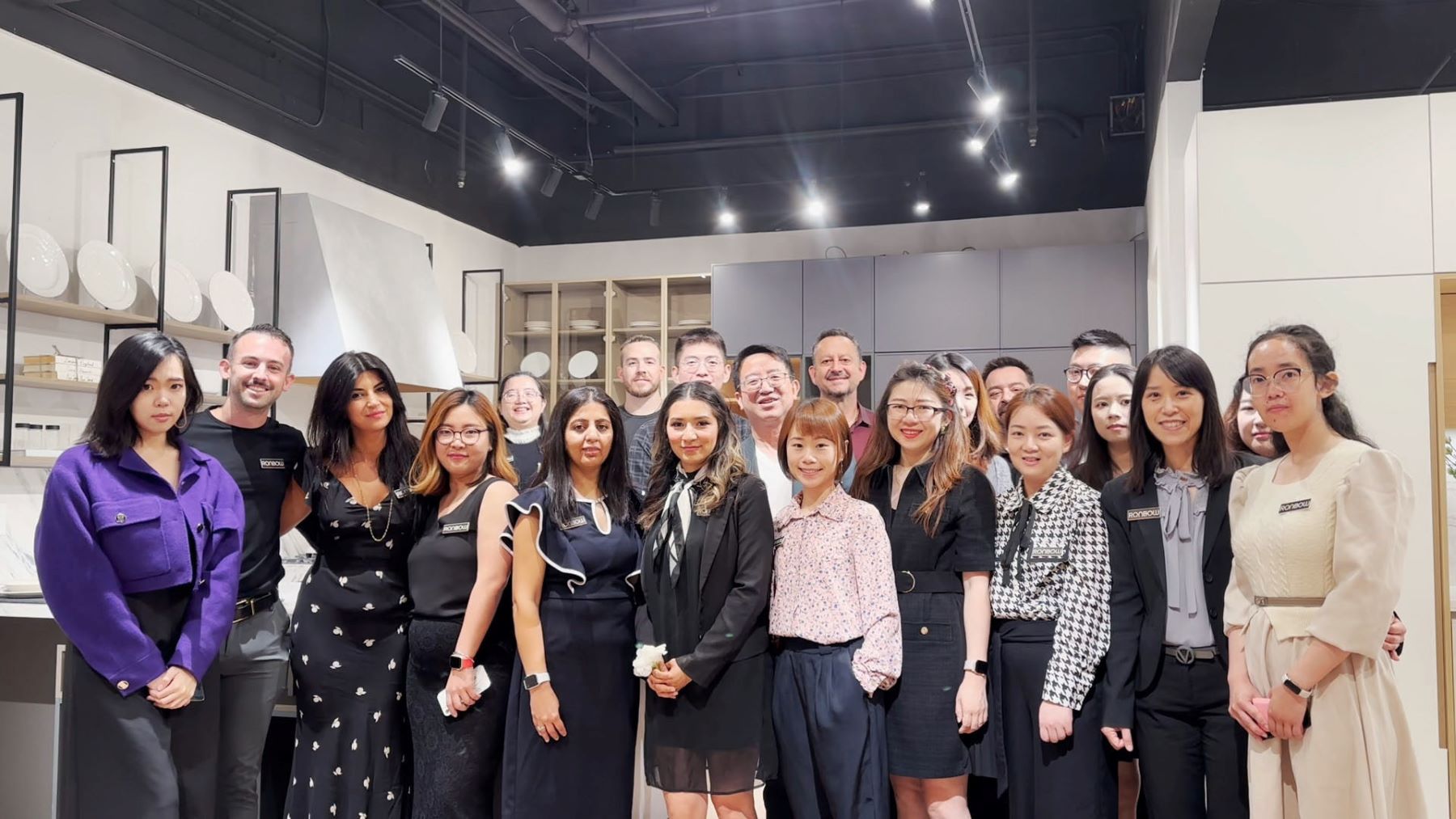 The Ronbow team gathered in a cabinetry showroom