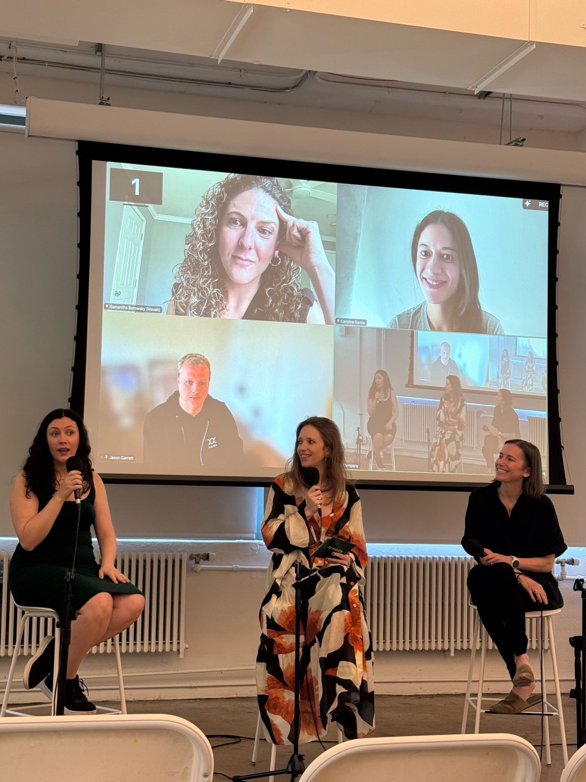 A Maven Clinic anniversary panel in New York, with Jason Garrett appearing by video on the large screen behind three speakers