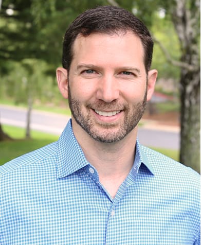 Jason Klein in a blue checked shirt, in the portrait published by Accel-KKR