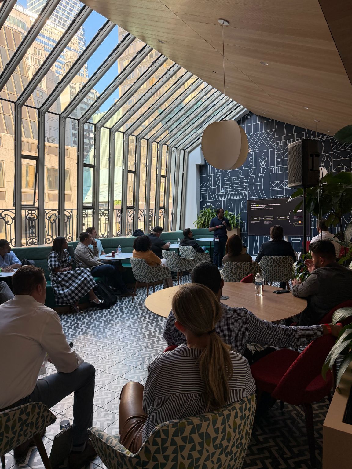 A speaker addresses seated attendees at a StrtupBoost and AWS gathering
