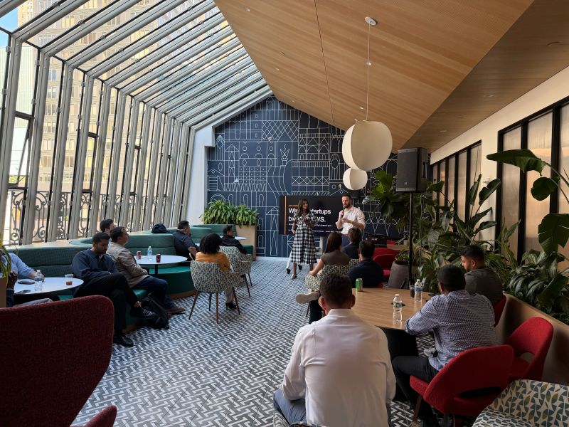 Attendees seated in a bright room during a StrtupBoost event with Amazon Web Services