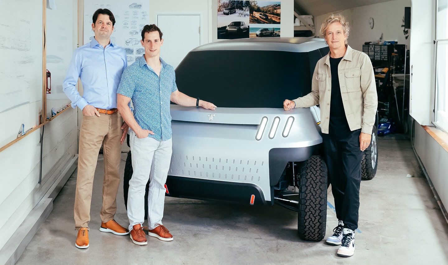 The TELO founding team standing with an early full-size electric truck model