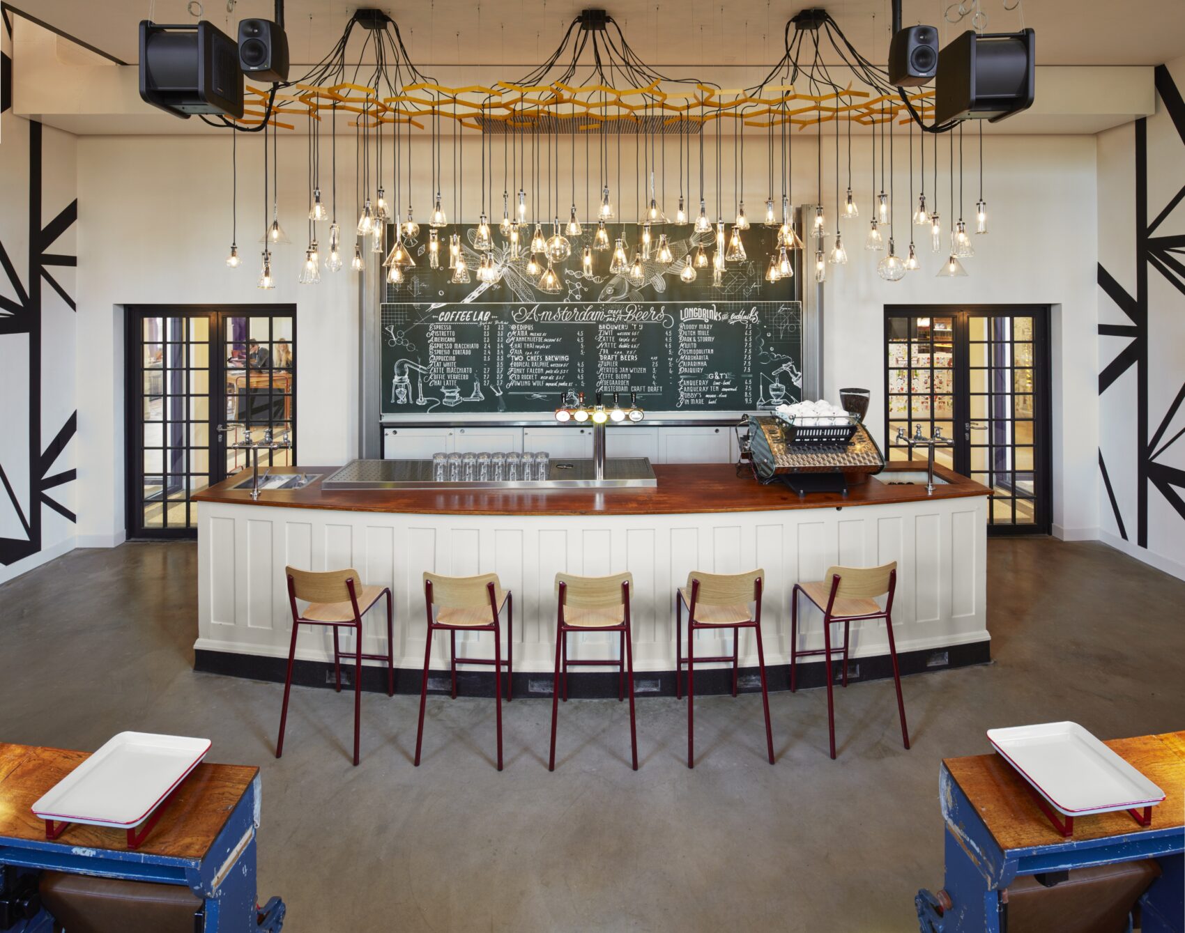 Generator's Auditorium Bar with hanging lights, counter seating and communal tables