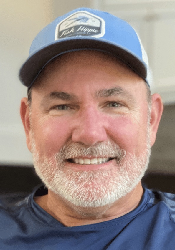 Jason Sprenkle wearing a blue cap and casual shirt