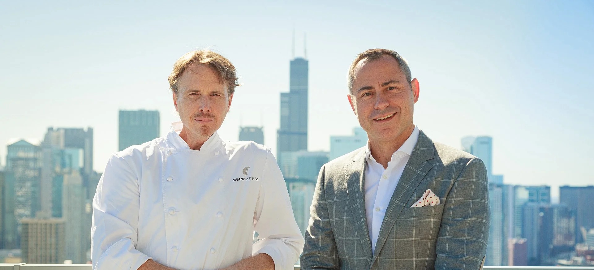 Chef Grant Achatz, left, and Jason Weingarten, right, with Chicago’s skyline behind them
