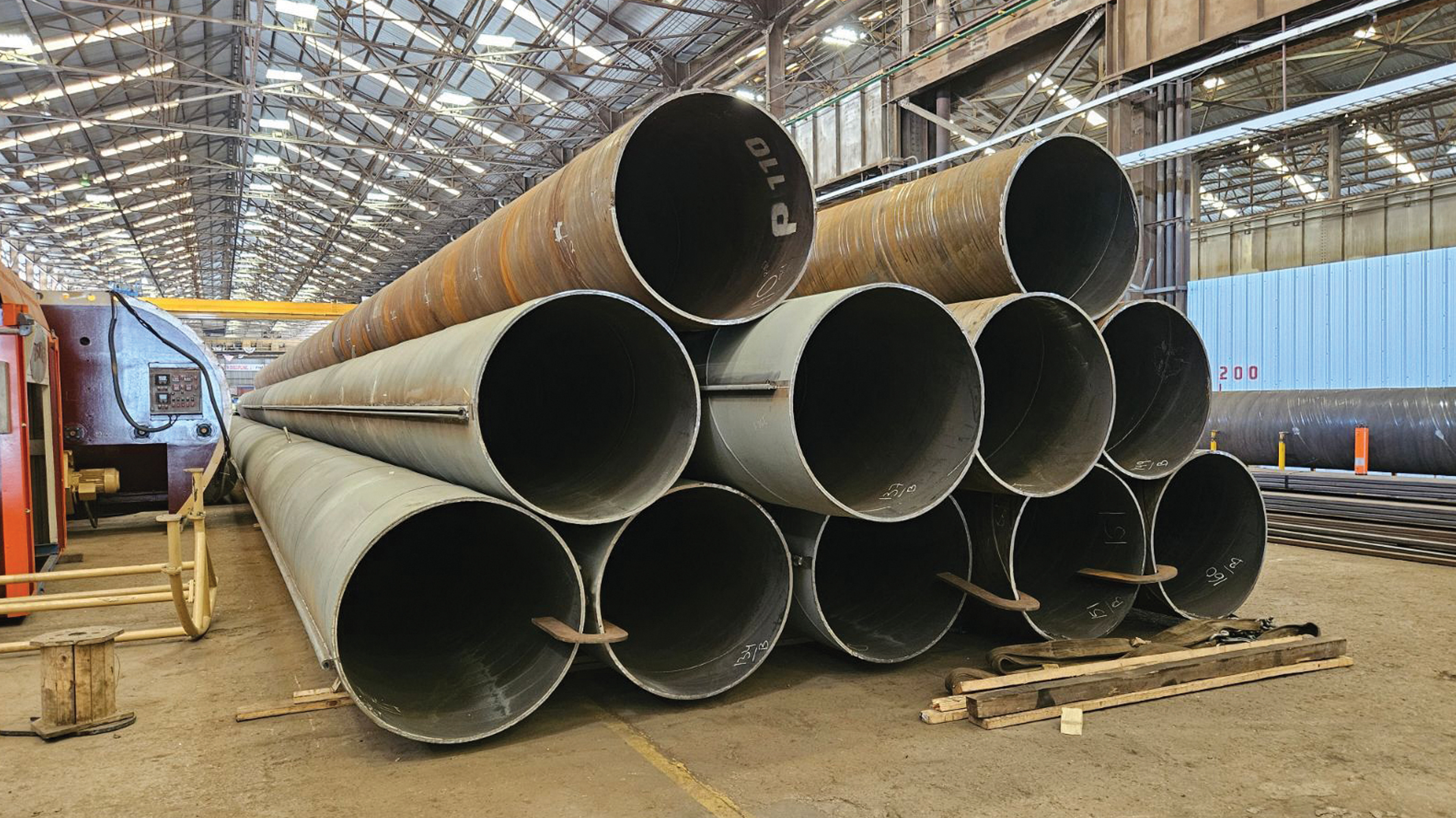 Large steel pipes stacked inside the Houston Fields HDM mill