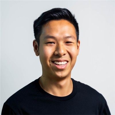 Jay Kurahashi-Sofue smiling against a light studio background