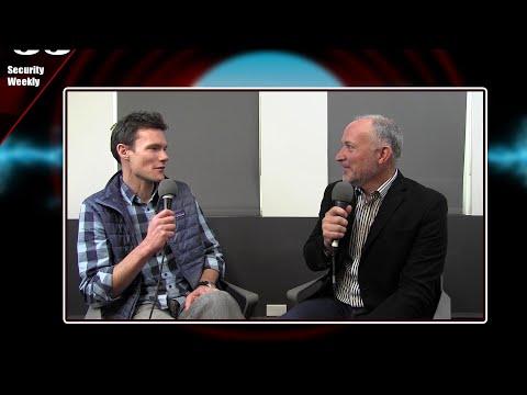 Jay Prassl, left, holding a microphone during a Security Weekly interview