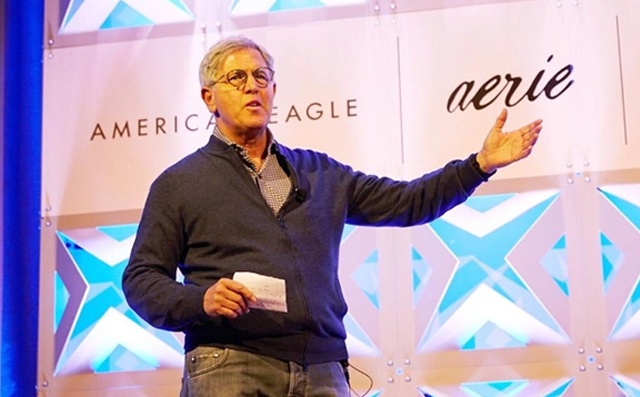 Jay Schottenstein speaking onstage with American Eagle and Aerie branding behind him