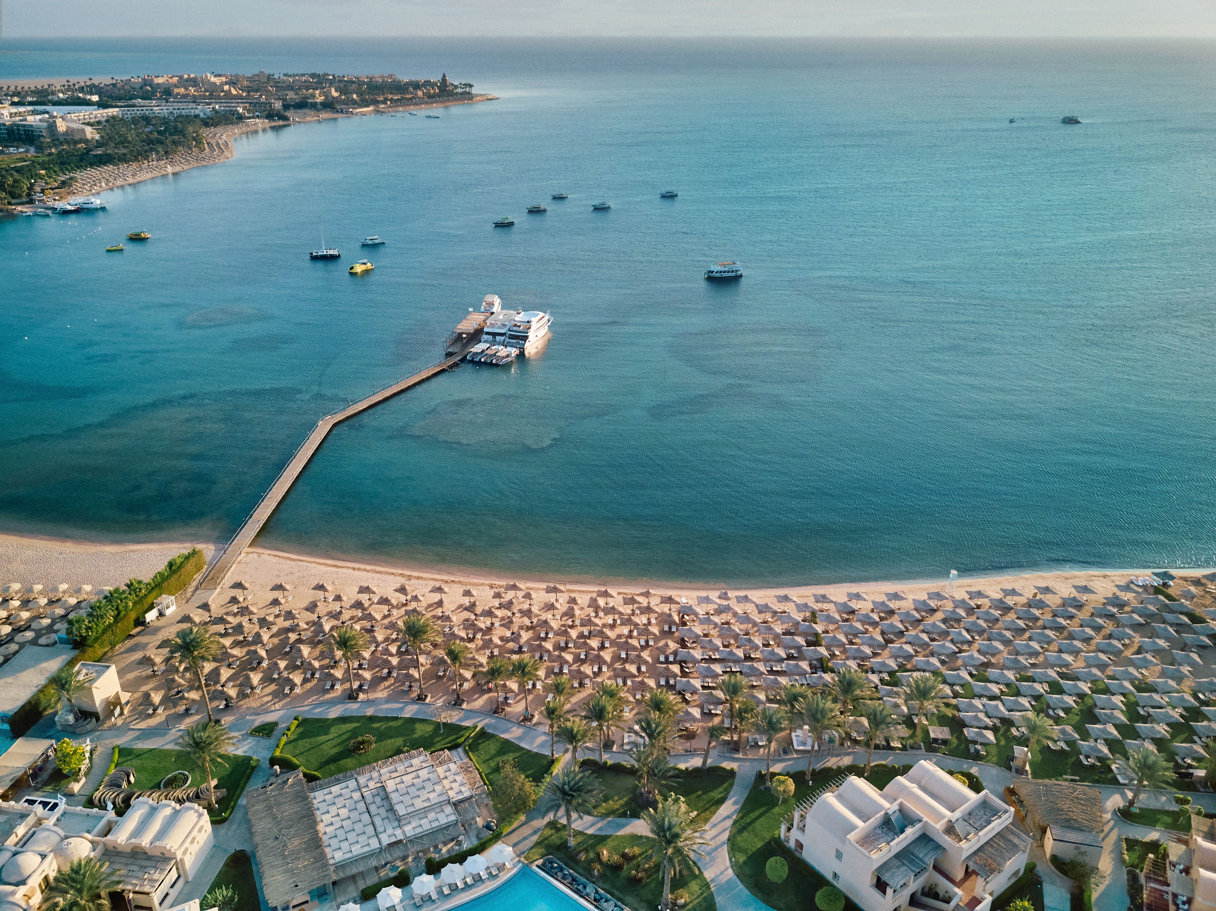Aerial drone view of Makadi Bay beach and the turquoise Red Sea fronting JAZ Makadi Oasis Resort