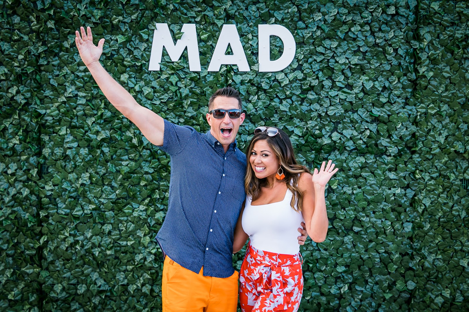 JB and Gina Kellogg smiling and waving at Madwire’s annual Orange party