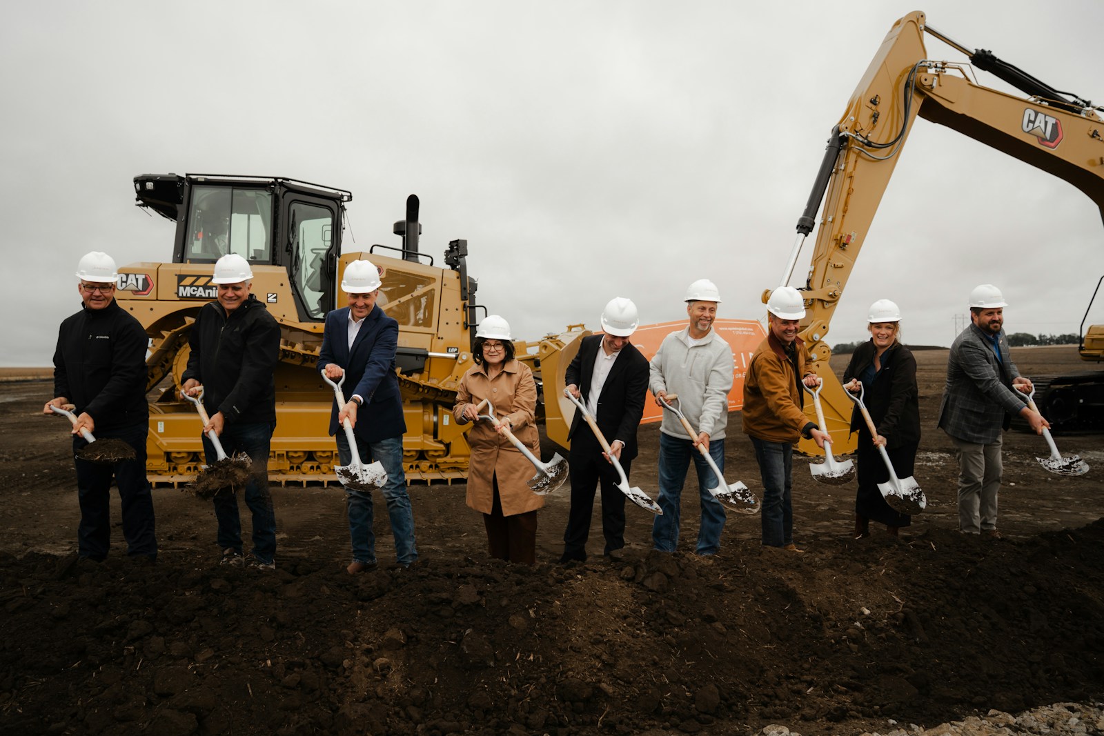 Officials and JBS representatives turn soil with ceremonial shovels at the Perry, Iowa groundbreaking