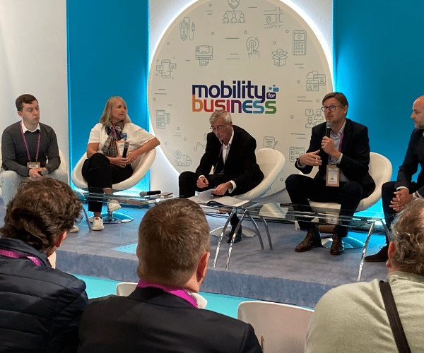A panel discussion at Mobility for Business, with speakers seated before an audience.