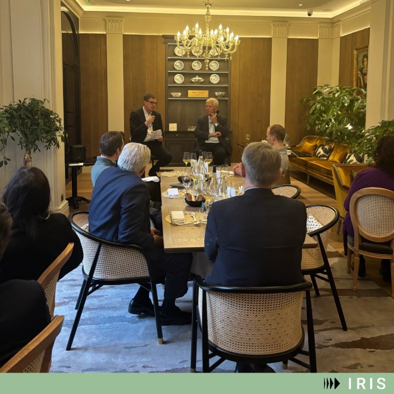Jean-Luc Robert and Curt Gunsenheimer speaking to guests around a lunch table in Paris