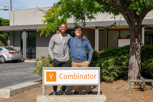Jean-Michael Diei and Matthew Krager standing behind a Y Combinator sign