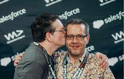 Jeff Atwood, left, kisses Ben Dumke-von der Ehe on the cheek at a developer event.