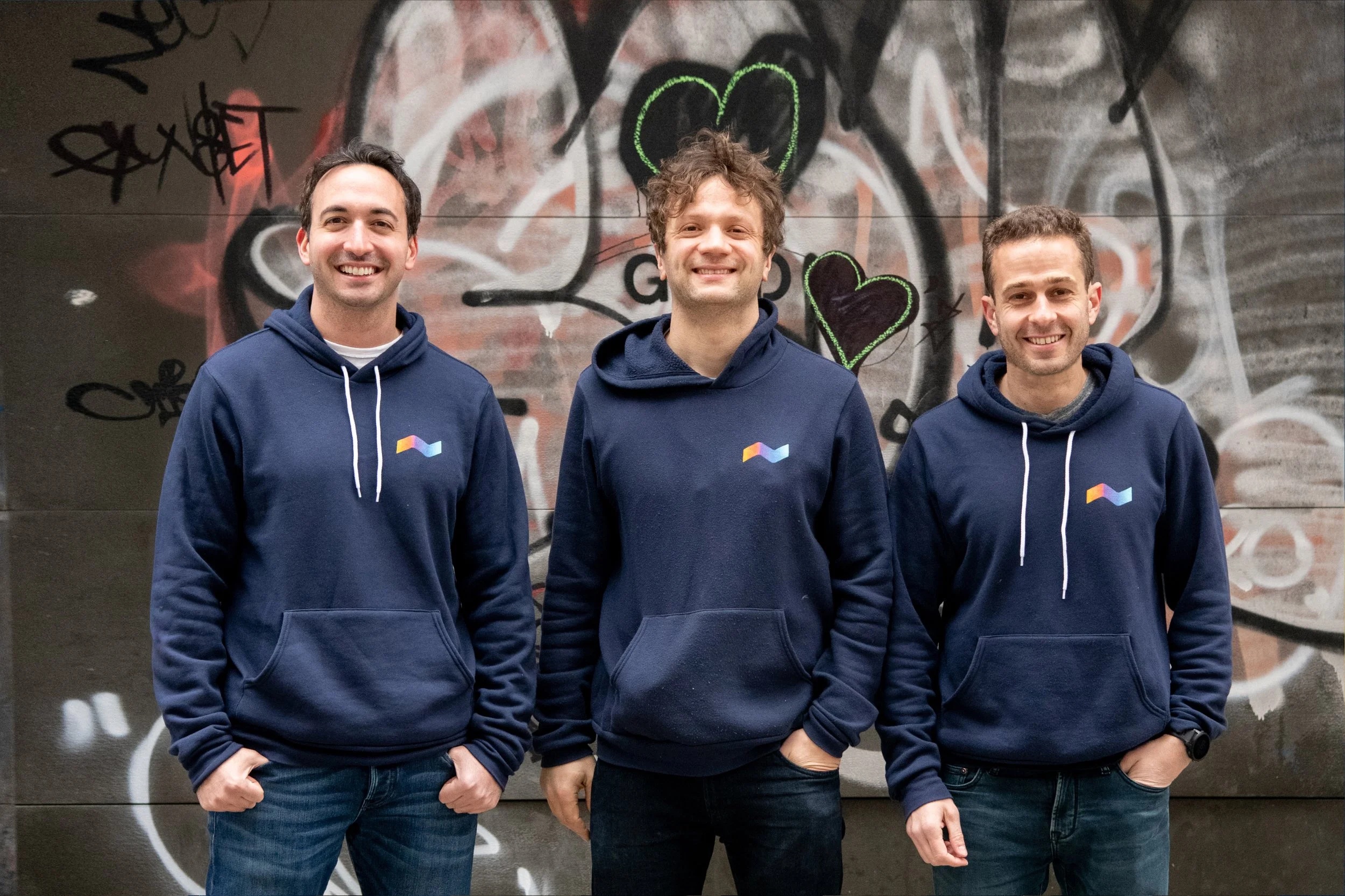 Runwise co-founders Michael Cook, Jeff Carleton and Lee Hoffman standing together in navy hoodies
