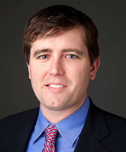 Jeff Carter in a dark jacket, blue shirt and red patterned tie