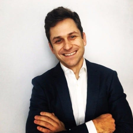 Jeff De Flavio smiling with his arms folded in a photograph accompanying AlleyCorp’s 2020 welcome