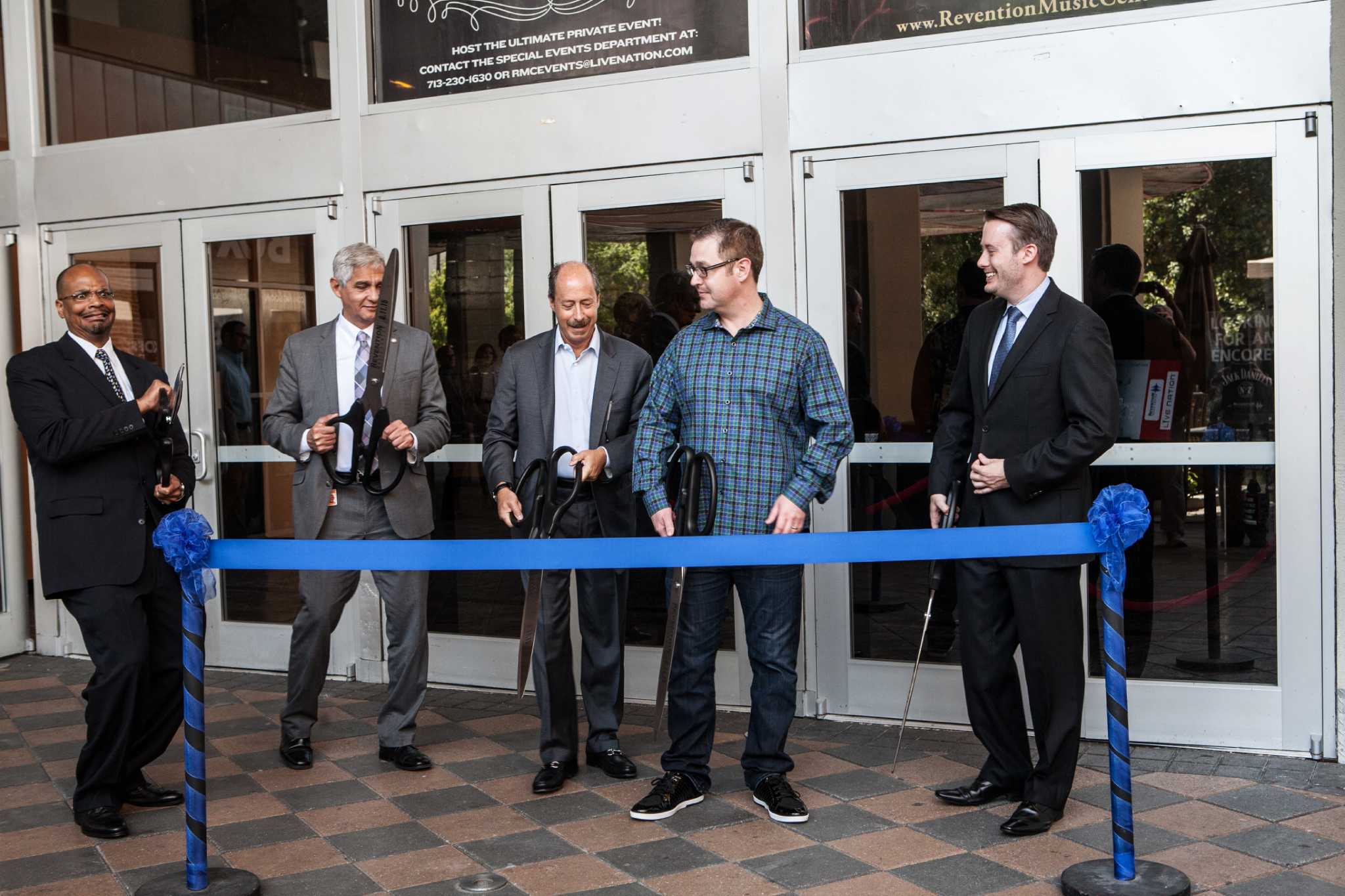 Jeff Doyle, second from right in a checked shirt, joins the August 2015 ribbon cutting at Revention Music Center in Houston.