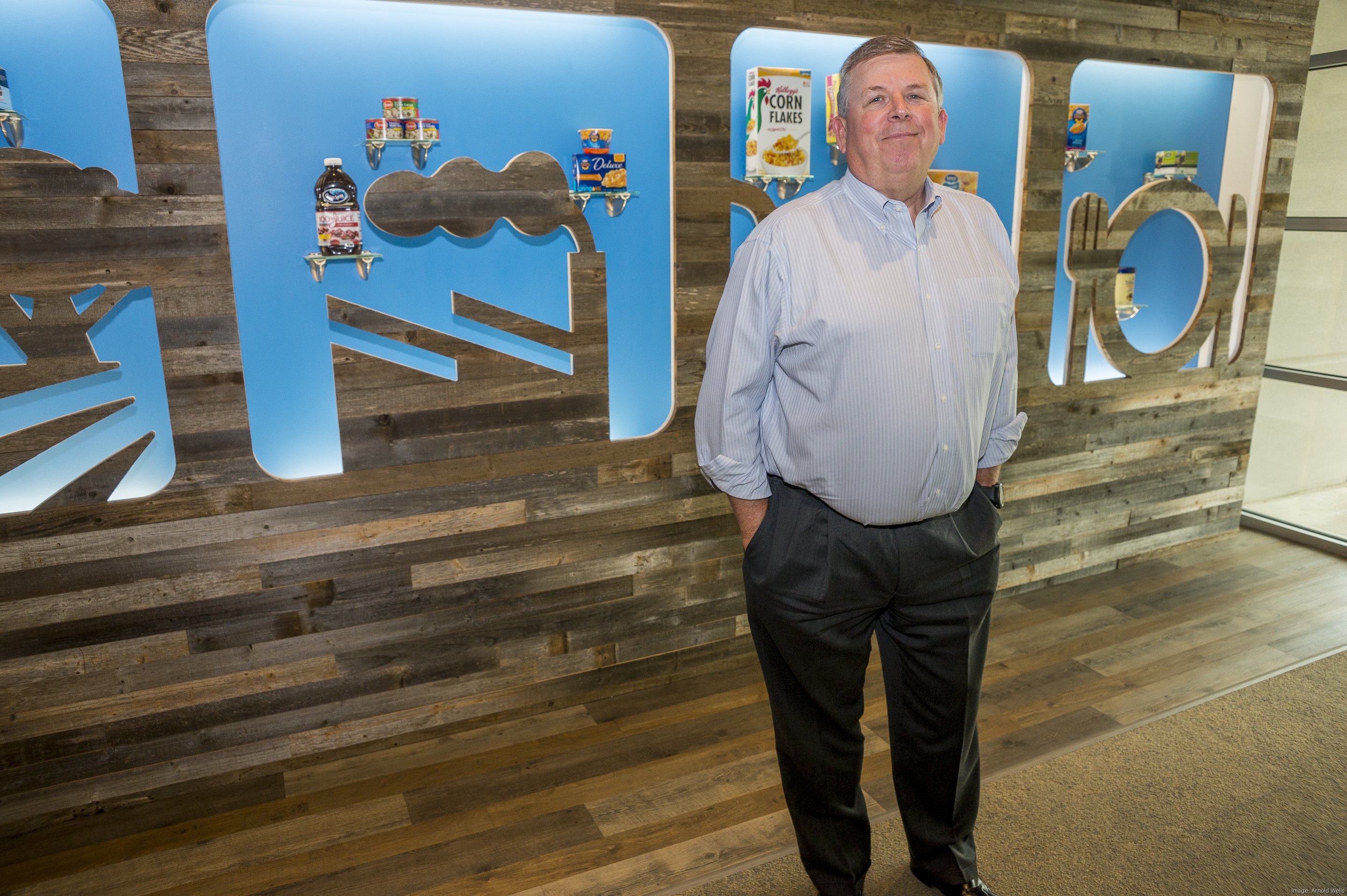 Jeff Eastman standing beside a display of food products in a 2017 press photograph