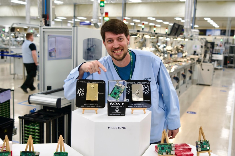Jeff Geerling beside Raspberry Pi production milestones at the Sony factory