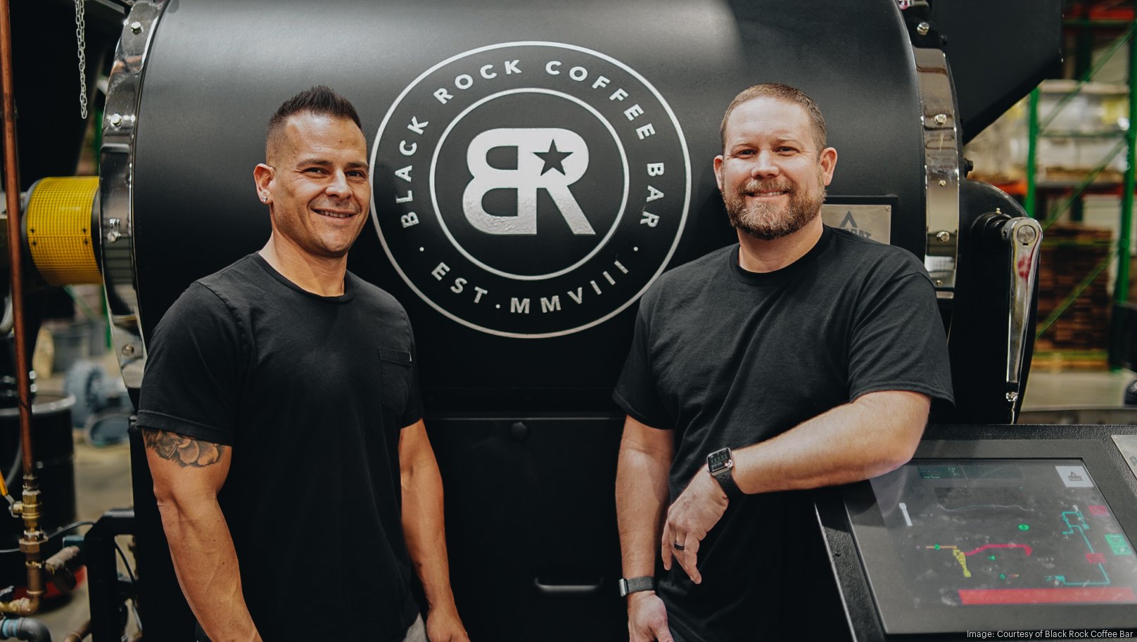 Daniel Brand, left, and Jeff Hernandez, right, beside a Black Rock coffee roaster