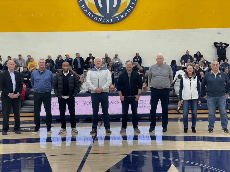 Jeff Hock, fourth from left, standing with fellow Moeller trustees on the school basketball court