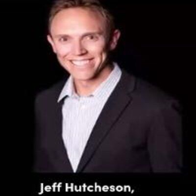 Archive photograph of Jeff Hutcheson in a dark jacket and striped shirt