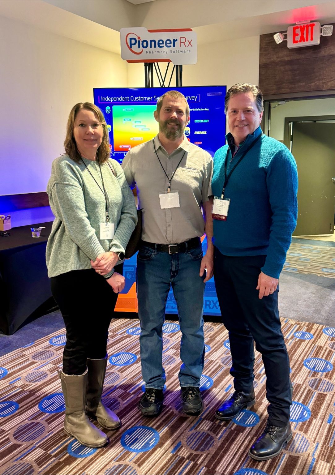 Jeff Key, right, with two early PioneerRx customers beside a company display at a Montana Pharmacy Association event