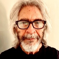 Jeff Lipscomb wearing glasses in a separate public portrait