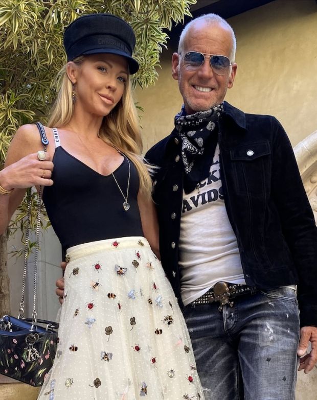 Carrie Stroup and Jeff Lubell standing together outdoors, Lubell in denim and a bandanna.