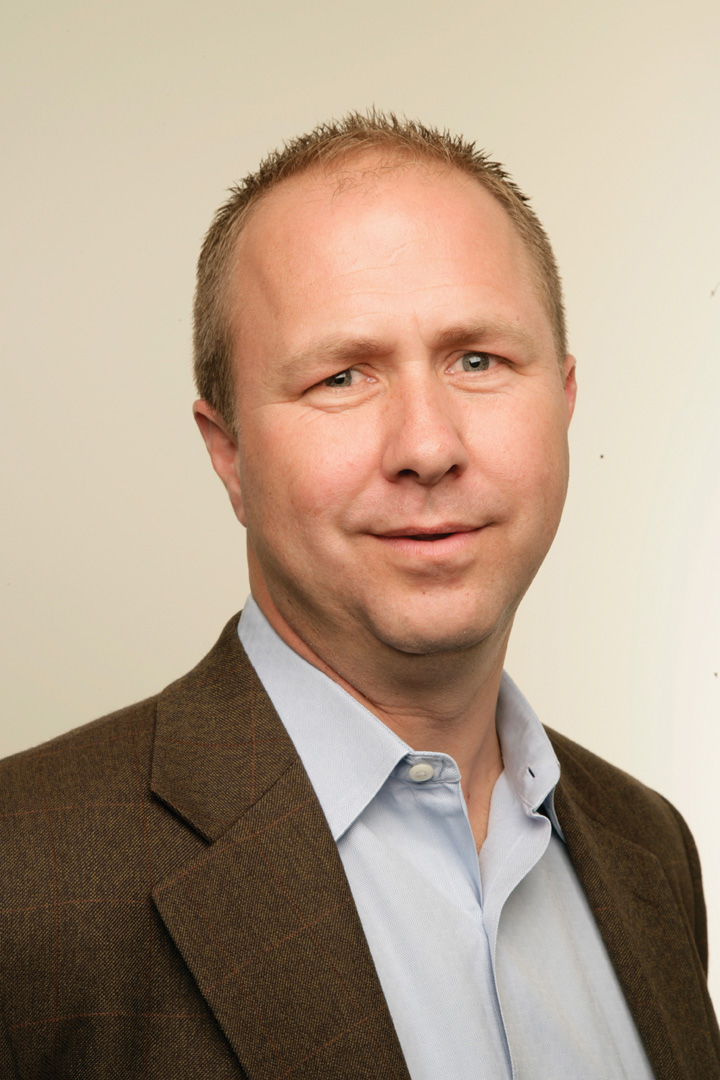 Archival photograph of Jeff Shelstad in a brown jacket and blue shirt