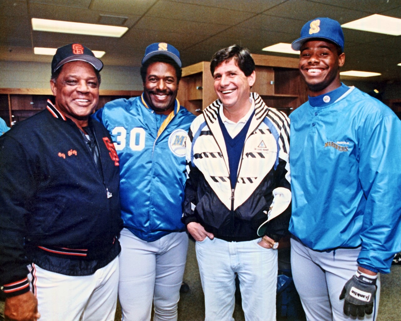 Willie Mays, Ken Griffey Sr., Jeff Smulyan and Ken Griffey Jr. smiling together during Smulyan’s Mariners ownership