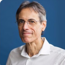Jeff Swartz in a white collared shirt against a blue background