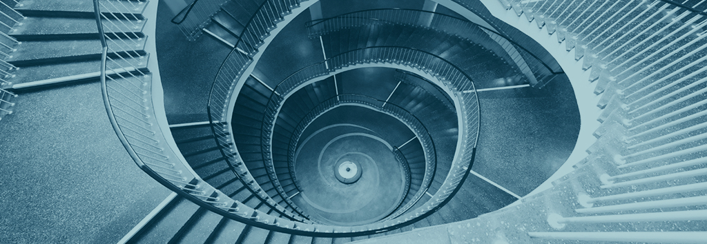 A spiral staircase photographed in blue tones