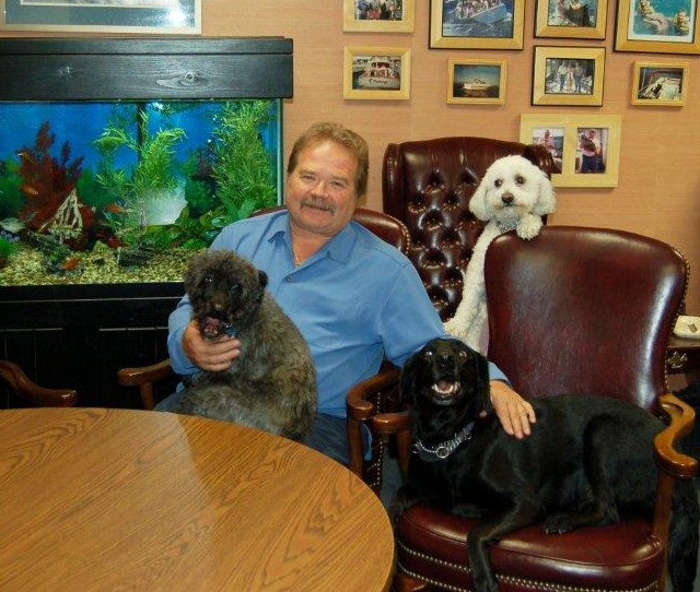 Jeffrey Barnhart in his office with his three dogs