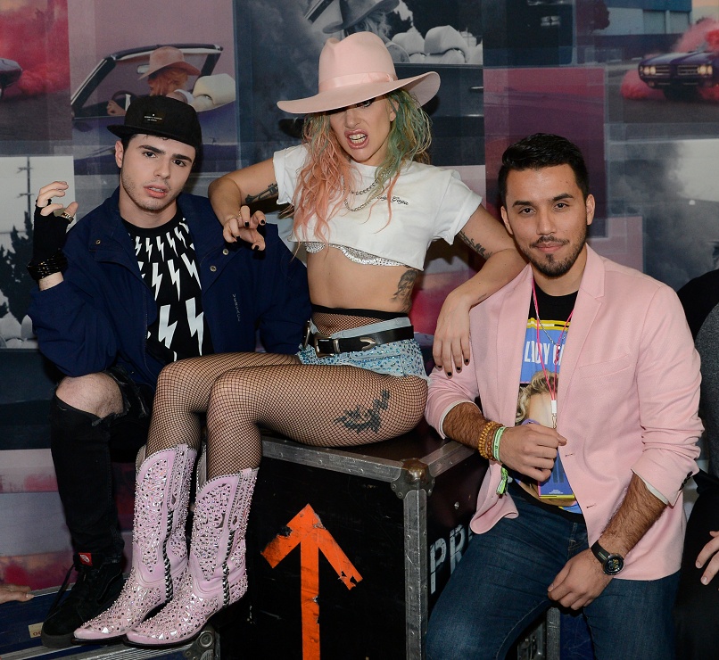 Jeffrey Campos, at right in a pink jacket, with Lady Gaga and another guest in 2017