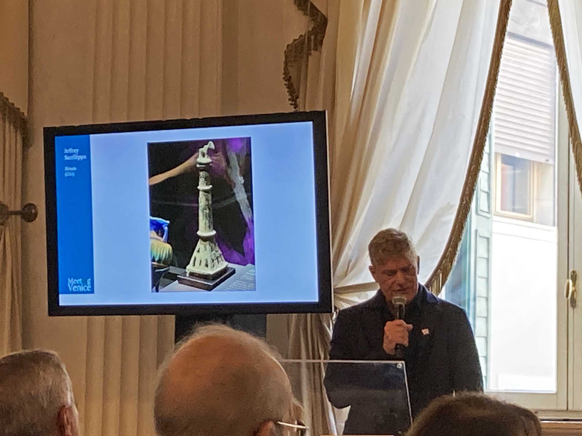 Jeffrey Sanfilippo speaking at a lectern during the perfume bottle association’s Venice meeting