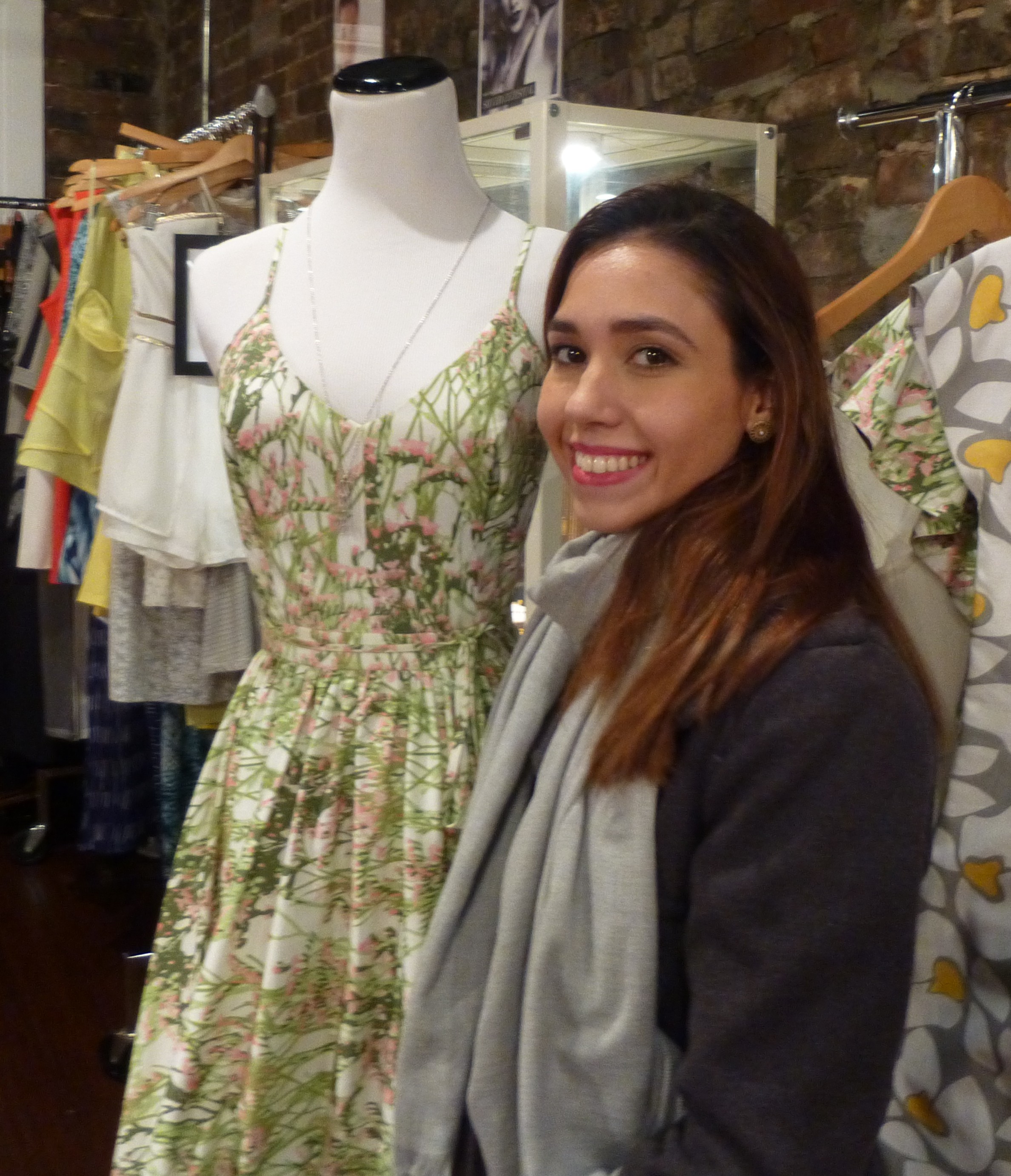 Designer Sofia Arana standing beside her designs at Red Light PR’s 2014 showroom preview